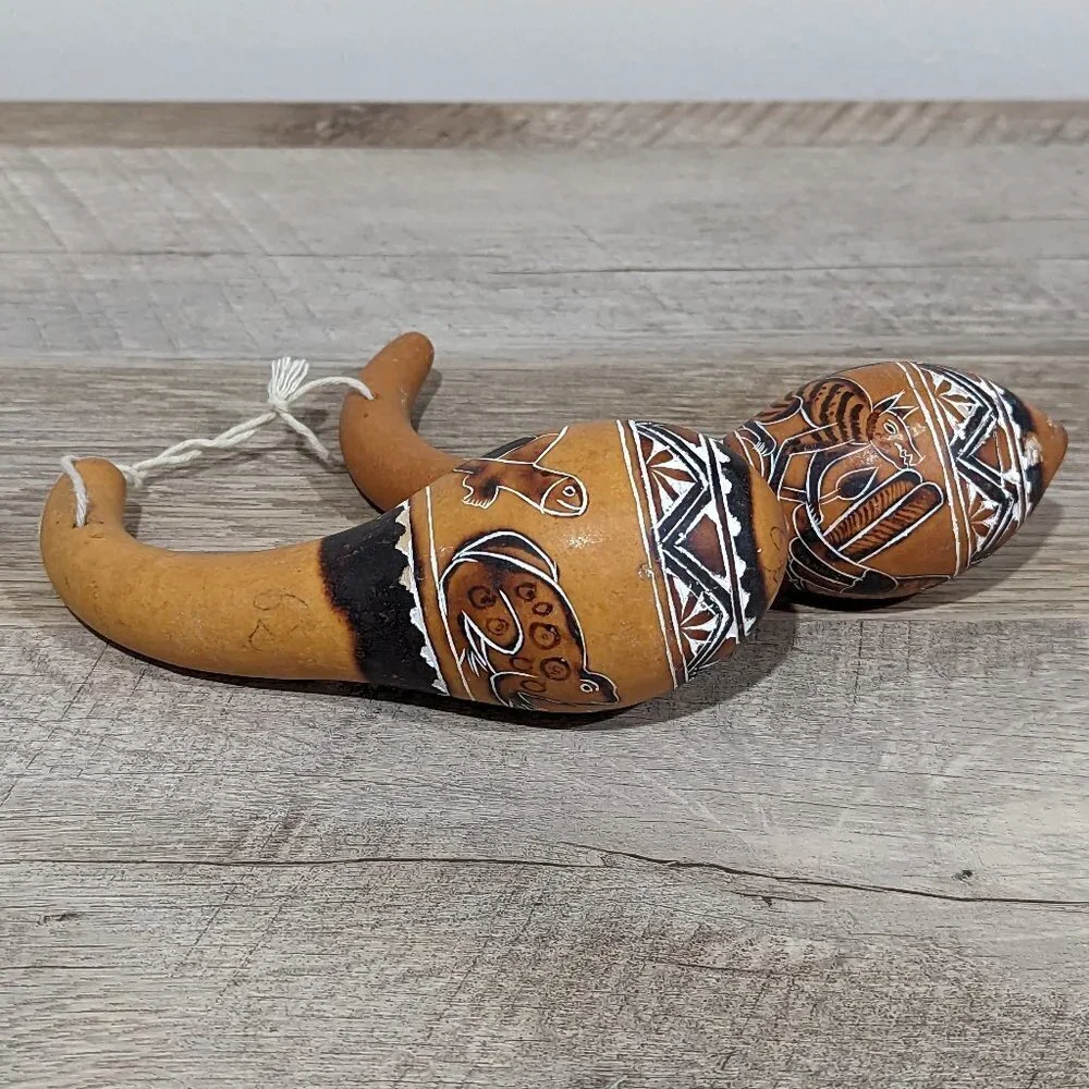 Two vintage etched and painted handmade gourd maracas with animals